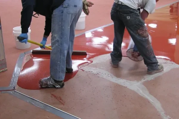 men-applying-epoxy-concrete-coating-on-floor